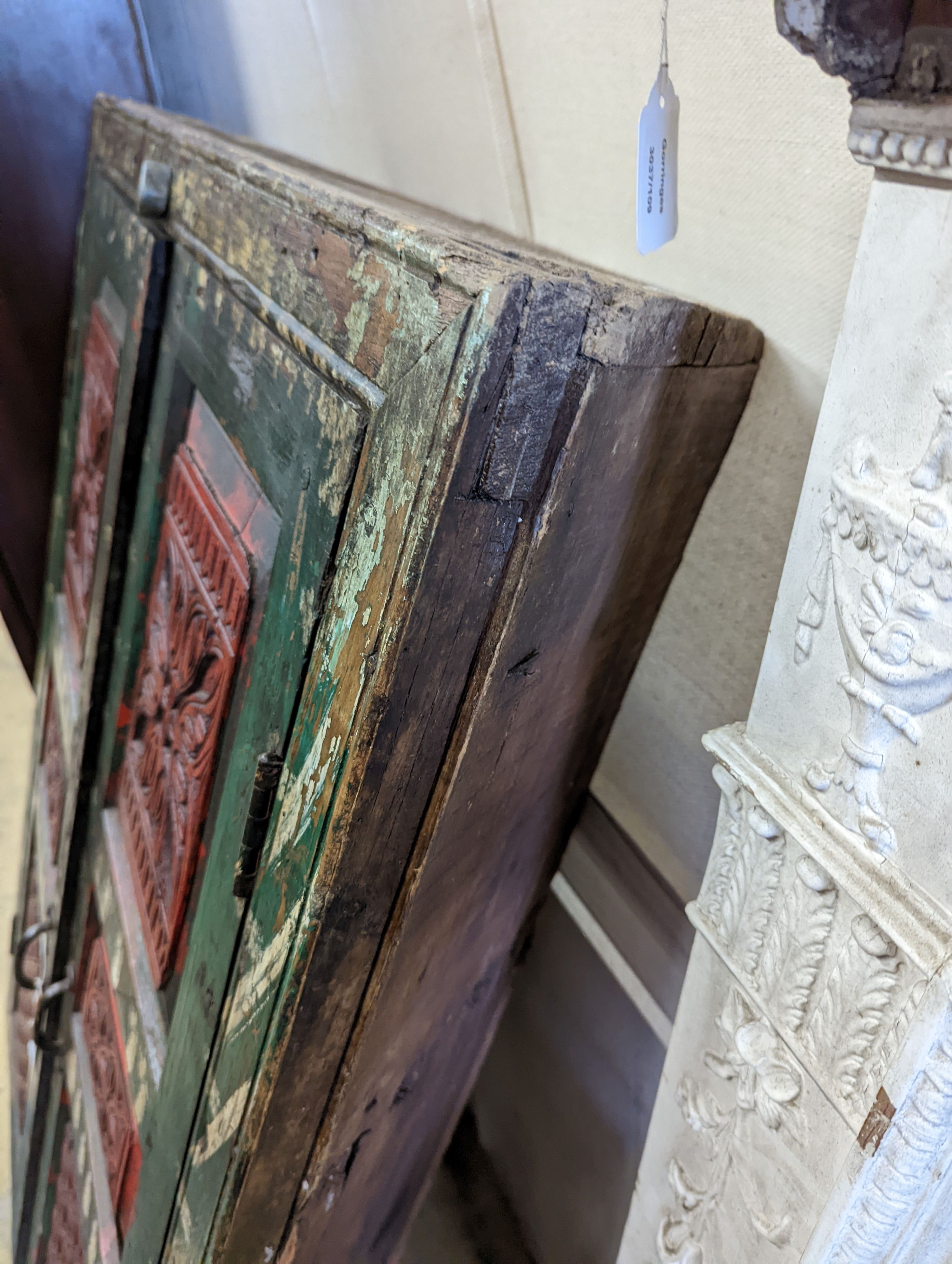 An Afghan painted carved hardwood corner cupboard, width 90cm, height 131cm
